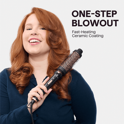 Woman with styled red hair using Pink Multi Curl 5-in-1 curling tool with 'One-Step Blowout' text on a light gray background.
