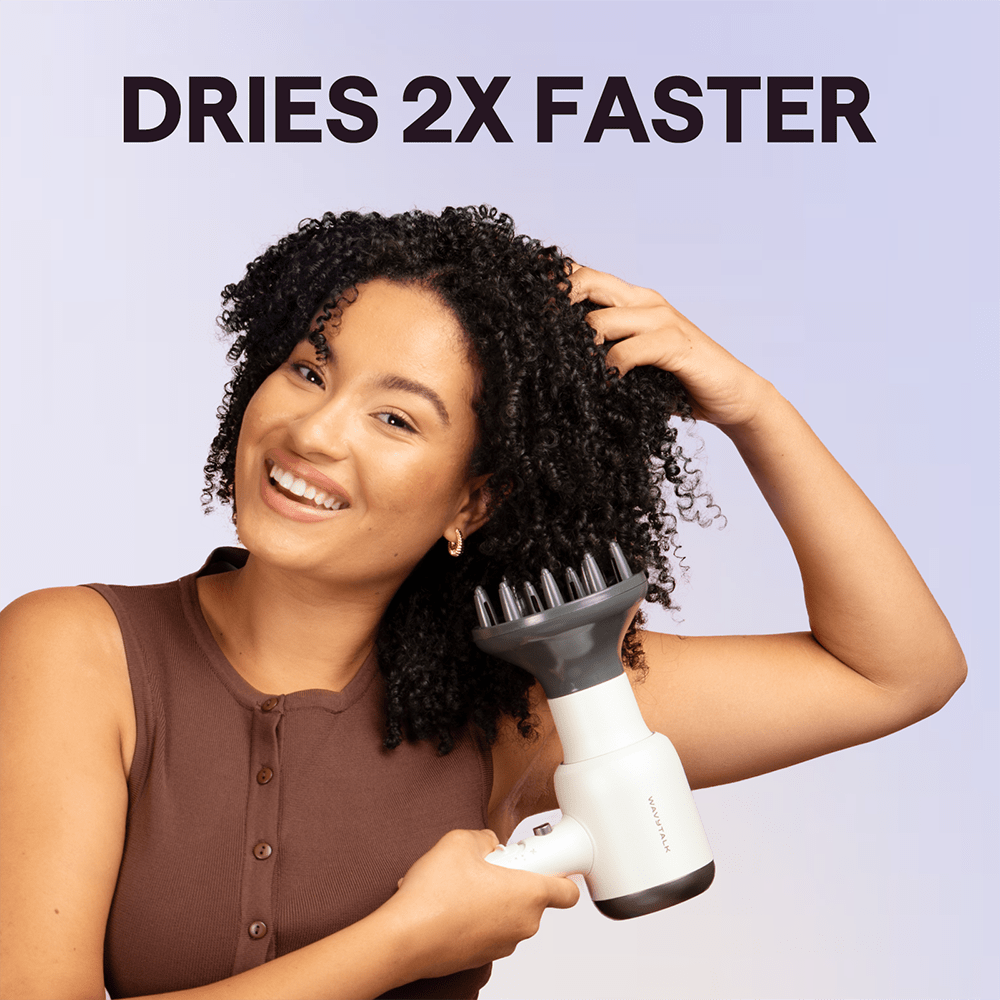White Blown Away hair dryer held by a woman, featuring the text "Dries 2X Faster" against a light purple background.
