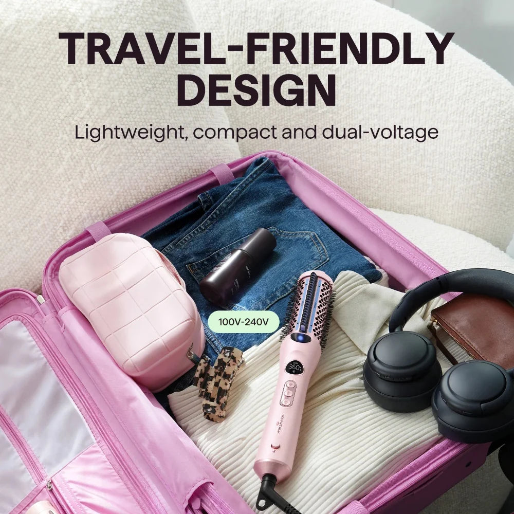A pink travel-friendly hair styling tool is shown inside an open pink suitcase, surrounded by travel items like jeans, a small pink pouch, headphones, and a wallet. Text on the image reads 'TRAVEL-FRIENDLY DESIGN' and 'Lightweight, compact and dual-voltage' with a badge indicating '100V-240V'.